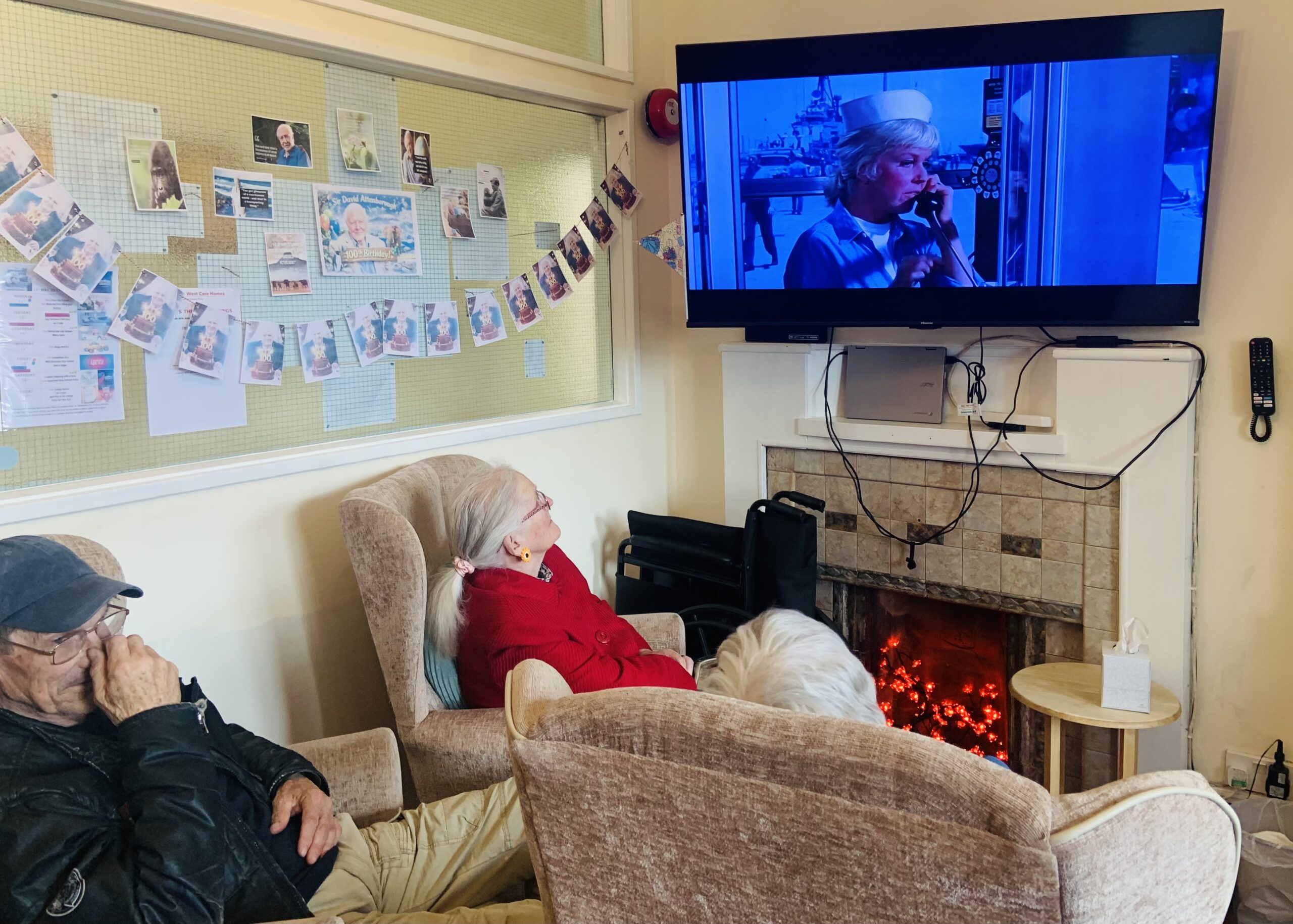Residents seated in armchairs watching the film 1 scaled