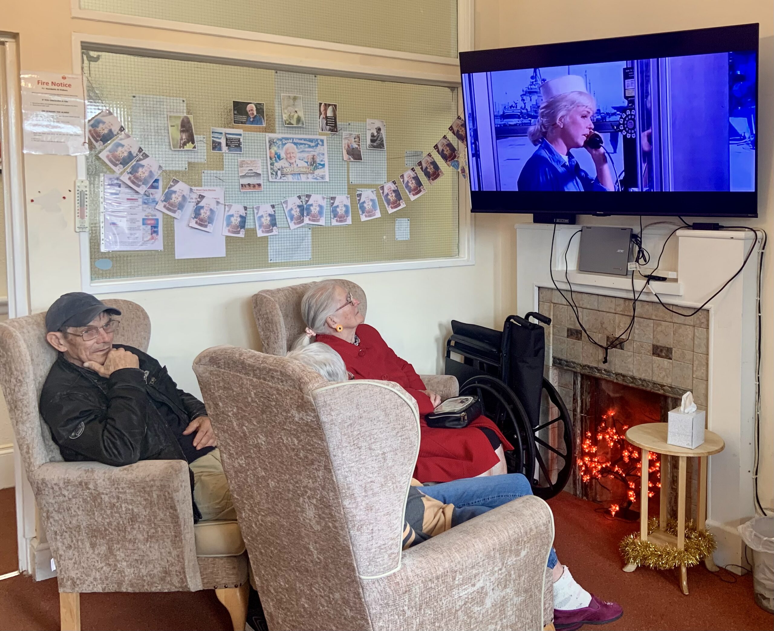 Residents seated in armchairs watching the film 2 scaled