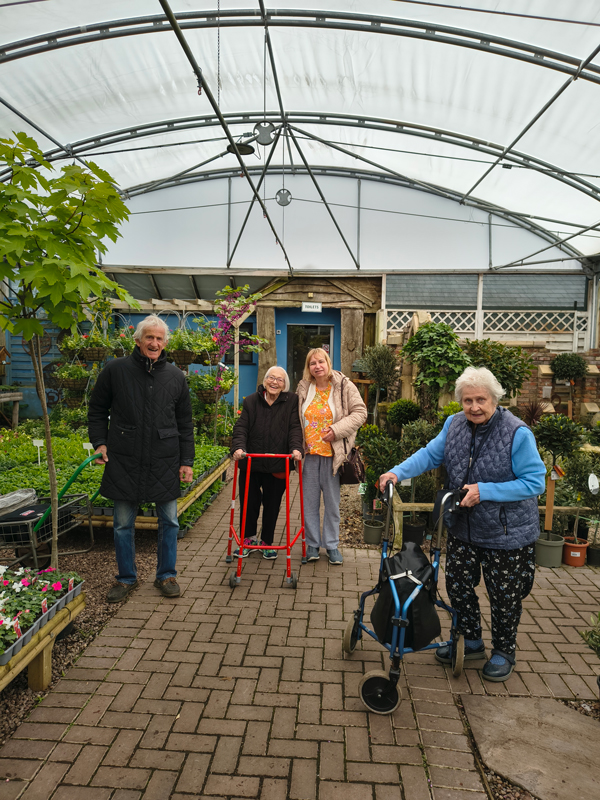 Residents walking around the garden centre smiling