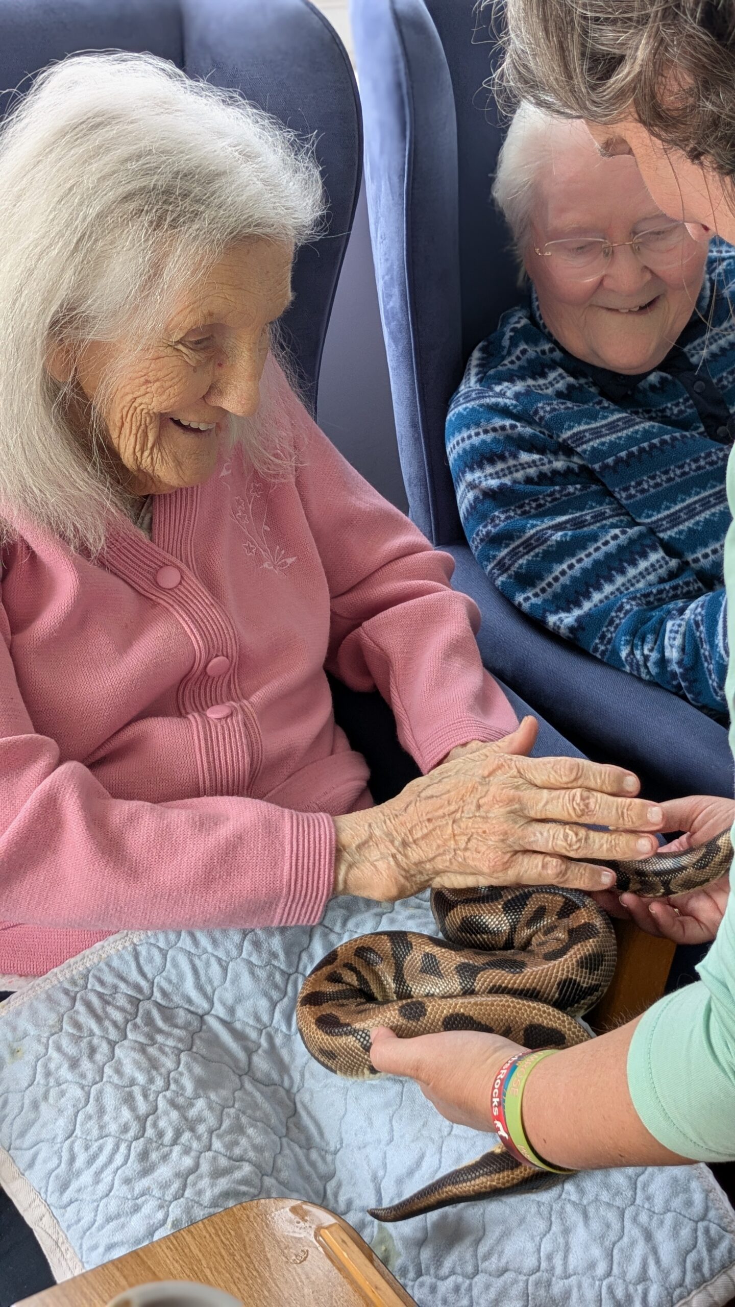 Ruth stroking a python smiling scaled