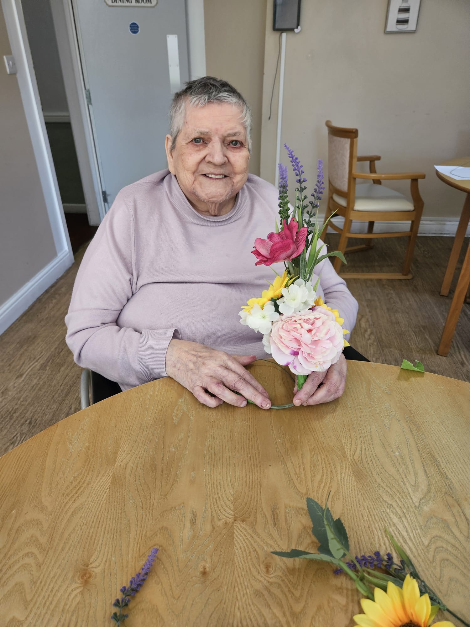 Sandra holding her finished flower arrangement