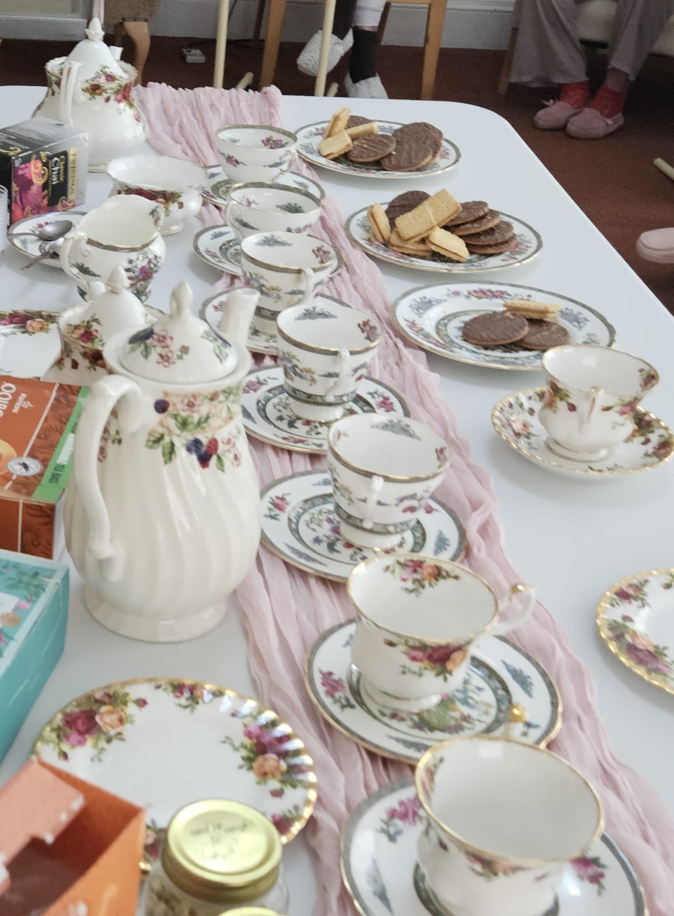 Table set out with tea set and plates of biscuits