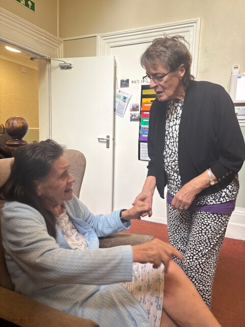 Two female residents talking hand in hand rotated