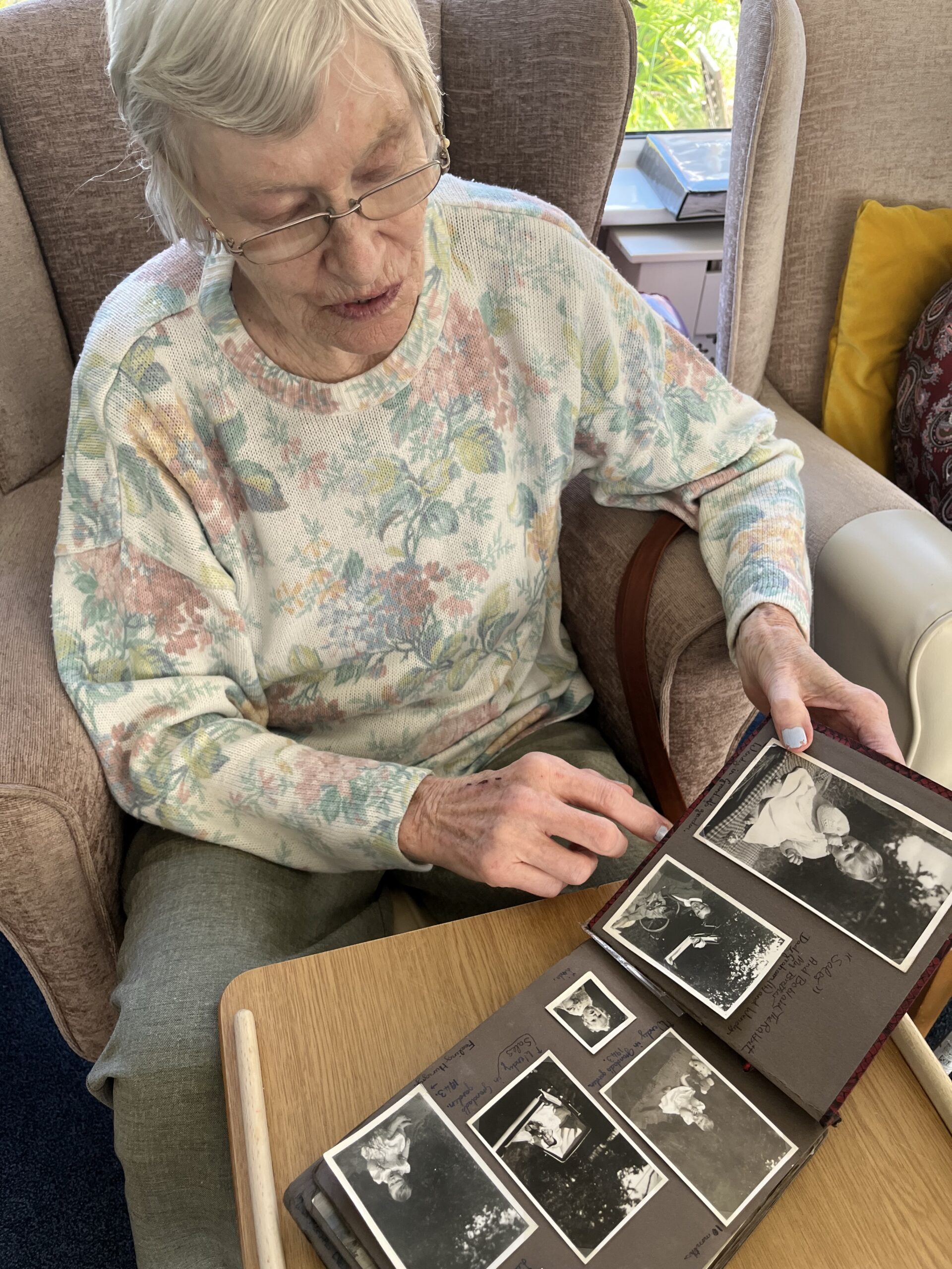 Wendy looking at black and white photos in an album scaled