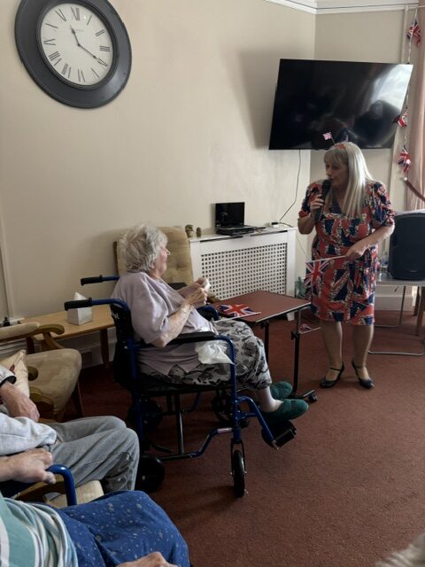 Zara singing to one resident rotated