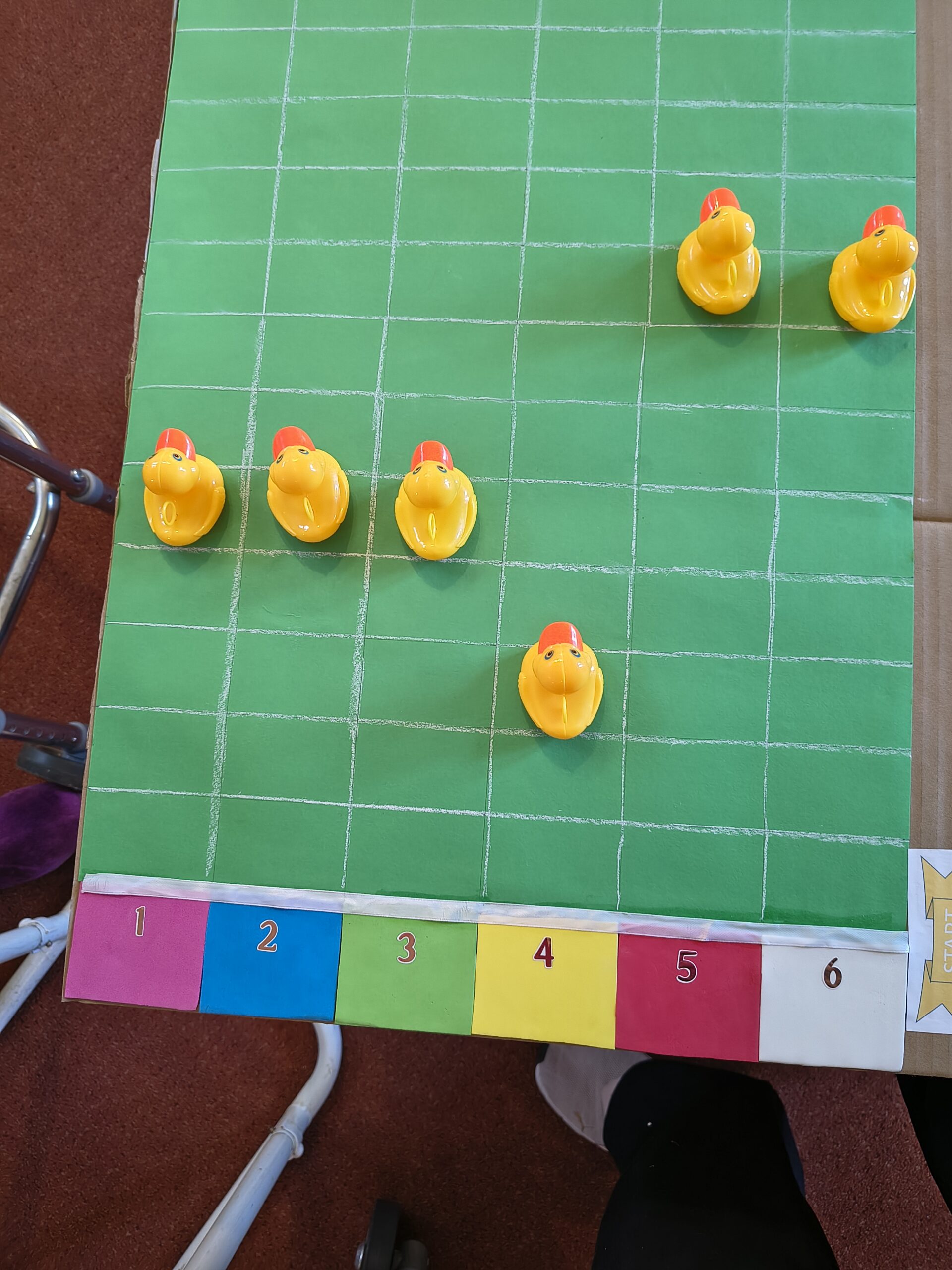 lastic duck racing game with the duck moving along the squares scaled