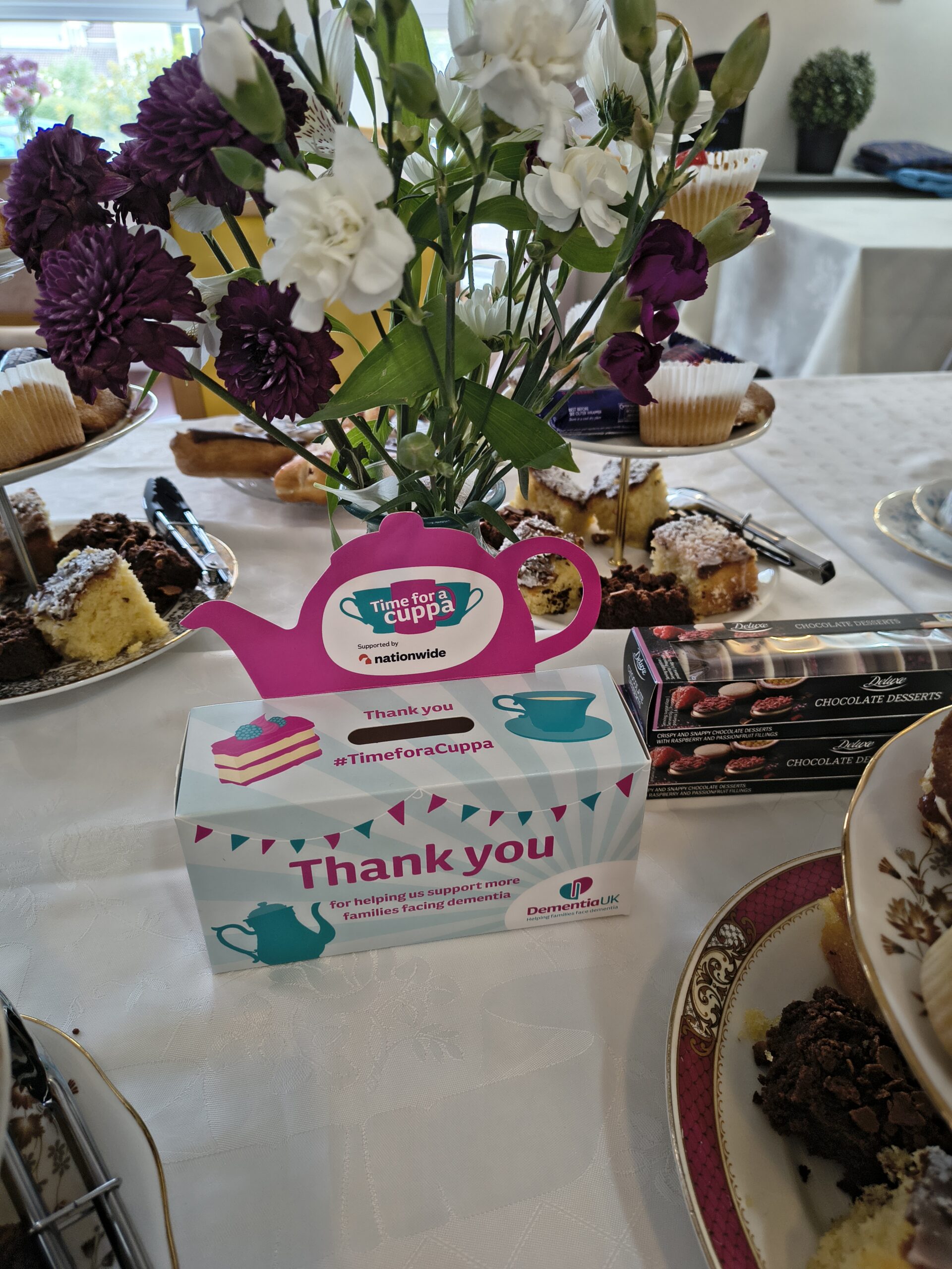 lose up of donation box on table of cakes scaled
